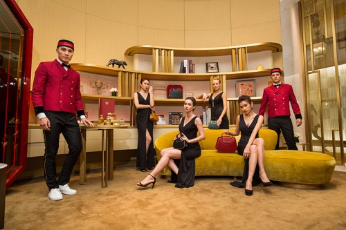 Cartier models and bell boys pose with the new collection